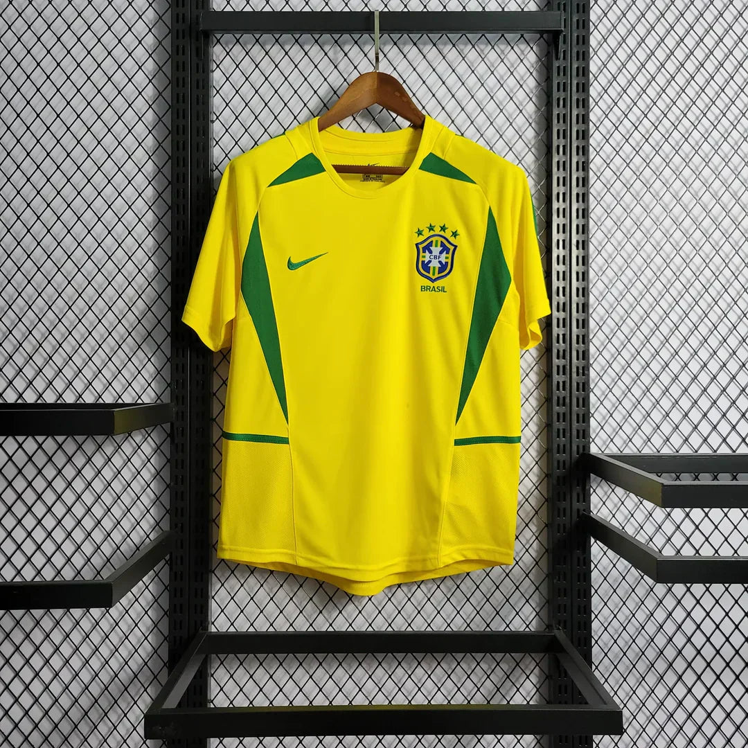 https://cdn.shopify.com/s/files/1/0911/7686/1985/files/BRAZIL2002HOMESHIRT1.webp?v=1731956135